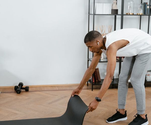 A focused man preparing for a workout session in a calm environment.